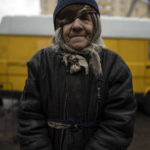 
              Oleksandr a Skolota, 83, poses for a picture after receiving free food from a soup kitchen in Bucha, in the outskirts of Kyiv, Ukraine, Saturday, April 9, 2022. (AP Photo/Rodrigo Abd)
            