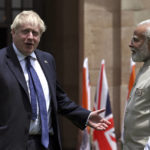 
              Britain's Prime Minister Boris Johnson, left, gestures as his Indian counterpart Narendra Modi watches before their meeting at Hyderabad House in New Delhi Friday, April 22, 2022. (Ben Stansall/Pool Photo via AP)
            