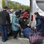 
              People board transport to move to Ukrainian city of Dnipro during an evacuation of civilians in Kramatorsk, Ukraine, Tuesday, April 19, 2022. (AP Photo/Andriy Andriyenko)
            