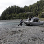
              FILE - Hunter Maltz, a fish technician for the Yurok tribe, pushes a jet boat into the Klamath River at the confluence of the Klamath River and Blue Creek as Keith Parker, a Yurok tribal fisheries biologist, watches near Klamath, Calif., on March 5, 2020. The U.S. Bureau of Reclamation must reserve enough water in a key lake for a fish species that's important to Native American tribes and endangered salmon species downriver are declining rapidly. (AP Photo/Gillian Flaccus, File)
            