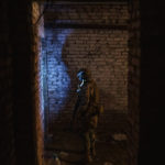 
              A Ukrainian serviceman walks in a basement used as a bomb shelter during Russian attacks in a village recently retaken by Ukrainian forces near Kharkiv, Ukraine, Saturday, April 30, 2022. (AP Photo/Felipe Dana)
            