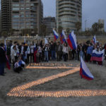 
              People gather near lit candles during an event organized by a group of Russia supporters to show solidarity with Moscow against Ukraine in Beirut, Lebanon, Saturday, April 9, 2022. (AP Photo/Hassan Ammar)
            