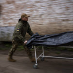 
              Darrell Loveless works moving dead bodies from refrigerated trucks to the morgue in Bucha, on the outskirts of Kyiv, Monday, April 25, 2022. (AP Photo/Emilio Morenatti)
            