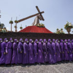 "Cucuruchos" carry a statue of Jesus Christ on a religious float during a Holy Thursday procession, in Antigua, Guatemala, Thursday, April 14, 2022. Processions and religious floats parade through the streets across the country during Holy Week, commemorating the last week of the earthly life of Jesus Christ culminating in his crucifixion on Good Friday and his resurrection on Easter Sunday. (AP Photo/Moises Castillo)