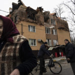 
              People walk and talk to each other in Irpin, on the outskirts of Kyiv, Ukraine, Saturday, April 2, 2022. As Russian forces pull back from Ukraine’s capital region, retreating troops are creating a “catastrophic" situation for civilians by leaving mines around homes, abandoned equipment and “even the bodies of those killed," President Volodymyr Zelenskyy warned Saturday. (AP Photo/Rodrigo Abd)
            