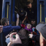 
              Rescue workers help a disabled elderly woman onto an evacuation train in Pokrovsk, eastern Ukraine, Tuesday, April 26, 2022. (AP Photo/Evgeniy Maloletka)
            