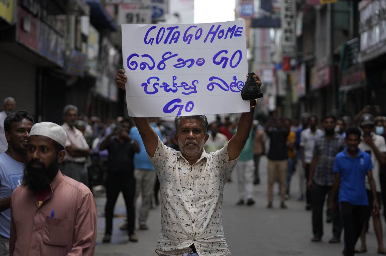 A Sri Lankan Muslim trader holds a placard demanding president Gotabaya Rajapaksa resign during a c...