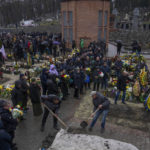 
              Family and friends attend the funeral of a soldier who was killed in action, at the Lychakiv cemetery, in Lviv, western Ukraine, Tuesday, April 5, 2022. (AP Photo/Nariman El-Mofty)
            
