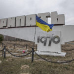
              A Ukrainian flag flies at the monument with a sign reads "Pripyat", name of the city, in the abandoned city of Pripyat near the Chernobyl Nuclear Power Plant, Ukraine, Tuesday, April 5, 2022. (AP Photo/Oleksandr Ratushniak)
            