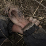 
              The body of Anton Ischenko, 20, a Ukrainian man who died while his village was occupied by Russian troops, lies in a field in Andriivka, Ukraine, Tuesday, April 5, 2022. Ukrainian President Volodymyr Zelenskyy accused Russian troops of gruesome atrocities in Ukraine and told the U.N. Security Council on Tuesday that those responsible should immediately be brought up on war crimes charges in front of a tribunal like the one set up at Nuremberg after World War II. (AP Photo/Vadim Ghirda)
            