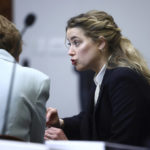 
              Actor Amber Heard speaks with her legal team in the courtroom at the Fairfax County Circuit Court in Fairfax, Va., Thursday, April 21, 2022. Actor Johnny Depp sued his ex-wife Amber Heard for libel in Fairfax County Circuit Court after she wrote an op-ed piece in The Washington Post in 2018 referring to herself as a "public figure representing domestic abuse." (Jim Lo Scalzo/Pool Photo via AP)
            