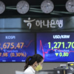 
              A currency trader watches monitors in front of screens showing the Korea Composite Stock Price Index (KOSPI), left, and the foreign exchange rate between U.S. dollar and South Korean won, at the foreign exchange dealing room of the KEB Hana Bank headquarters in Seoul, South Korea, Friday, April 29, 2022. Stocks were mostly higher in Asia on Friday after a rally on Wall Street led by technology companies. (AP Photo/Ahn Young-joon)
            