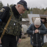 
              Zoya, the wife of 44 year old, Hennadiy Merchynskyi looks identifying along with police at the body of her husband, killed by Russian forces and dumped in a well in the village of Motyzhyn, Ukraine, Sunday, April 3, 2022.(AP Photo/Vadim Ghirda)
            