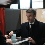 
              French President and centrist presidential candidate for reelection Emmanuel Macron casts his ballot for the first round of the presidential election, Sunday, April 10, 2022 in Le Touquet, northern France. Polls opened across France for the first round of the country's presidential election, where up to 48 million eligible voters will be choosing between 12 candidates. President Emmanuel Macron is seeking a second five-year term, with a strong challenge from the far right. (AP Photo/Thibault Camus, Pool)
            