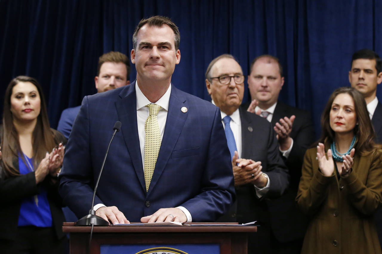 FILE - Oklahoma Gov. Kevin Stitt is applauded after speaking at a news conference, Nov. 1, 2019, in...