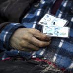 
              Identification cards on a man as policemen work on the indentification process following the killing of civilians in Bucha, before sending the bodies to the morgue, on the outskirts of Kyiv, Ukraine, Wednesday, April 6, 2022. (AP Photo/Rodrigo Abd)
            