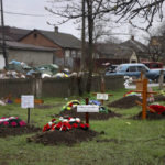 
              Graves of local residents who died during the fighting with Russia are seen in a street behind private houses in an area that Russian-backed separatists claim to control in the Ukraine city of Mariupol, Wednesday, April 13, 2022. (AP Photo/Alexei Alexandrov)
            