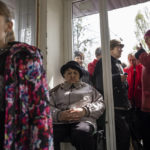 
              People wait for food and medicine distribution, in Kramatorsk, Ukraine, Tuesday, April 19, 2022. Russian forces attacked along a broad front in eastern Ukraine on Tuesday as part of a full-scale ground offensive to take control of the country's eastern industrial heartland in what Ukrainian officials called a "new phase of the war." (AP Photo/Petros Giannakouris)
            