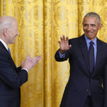 
              President Joe Biden applauds as former President Barack Obama arrives on stage during an event about the Affordable Care Act, in the East Room of the White House in Washington, Tuesday, April 5, 2022. (AP Photo/Carolyn Kaster)
            