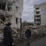 
              A boy is searching for his cat as he walks outside a destroyed apartment building in the town of Borodyanka, Ukraine, on Saturday, April 9, 2022. Russian troops occupied the town of Borodyanka for weeks. Several apartment buildings were destroyed during fighting between the Russian troops and the Ukrainian forces in the town around 40 miles northwest of Kiev. (AP Photo/Petros Giannakouris)
            