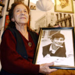 
              FILE - Mexico's human rights activist Rosario Ibarra de Piedra shows a photo of her son Jesus who disappeared during Mexico's so called "dirty war", at her home in Mexico City, Nov. 5, 2003. Ibarra, whose long struggle to learn the fate of her disappeared son helped develop Mexico's human rights movement and led her to become the country's first female presidential candidate, died Saturday, April 16, 2022. She was 95. (AP Photo/Jose Luis Magana, File)
            