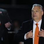 
              Hungary's Prime Minister Viktor Orban acknowledges cheering supporters during an election night rally in Budapest, Hungary, Sunday, April 3, 2022. Early partial results in Hungary's national election are showing a strong lead for the right-wing party of pro-Putin nationalist Orban as he seeks a fourth consecutive term. (AP Photo/Petr David Josek)
            