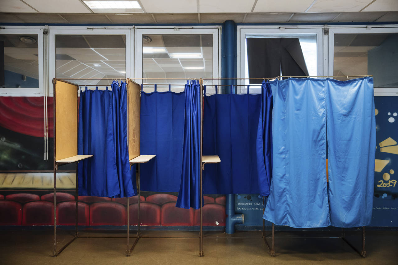 A voting booths at a polling station is being set up in Montreuil, east of Paris, Saturday, April 2...