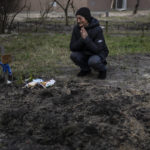 
              FILE - Tanya Nedashkivs'ka, 57, mourns the death of her husband on the site where he was buried, in Bucha, on the outskirts of Kyiv, Ukraine, Monday, April 4, 2022. (AP Photo/Rodrigo Abd)
            