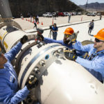 
              Southern Nevada Water Authority maintenance mechanics, from left, Jason Dondoy, Patrick Smith and Tony Mercado install a spacer flange after removing an energy dissipator at the Low Lake Level Pumping Station (L3P3) at Lake Mead National Recreation Area on Wednesday, April 27, 2022, outside of Las Vegas. The water supply for Las Vegas has marked a milestone, with the start of pumping through a new facility drawing water for some 2.4 million residents and 40 million tourists from deeper in Lake Mead and the dropping of the drought-depleted surface level falls below the first of three intakes at the crucial Colorado River reservoir behind Hoover Dam. (Chase Stevens/Las Vegas Review-Journal via AP)
            