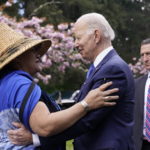 
              President Joe Biden talks with Teri Gobin, Chairwoman, Tulalip Tribes, after signing an executive order intended to help restore national forests devastated by wildfires, drought and blight, during an event at Seward Park on Earth Day, Friday, April 22, 2022, in Seattle. (AP Photo/Andrew Harnik)
            