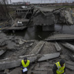 
              Engineers inspect the state of destruction of the bridge that connects Kyiv with Irpin, Ukraine, Wednesday, April 13, 2022. (AP Photo/Rodrigo Abd)
            