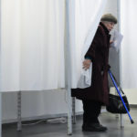 
              A woman votes in Budapest, Hungary, Sunday, April 3, 2022. Hungary's nationalist prime minister, Viktor Orban, seeks a fourth straight term in office, a coalition of opposition parties are framing the election as a referendum on Hungary's future in the West. (AP Photo/Petr David Josek)
            