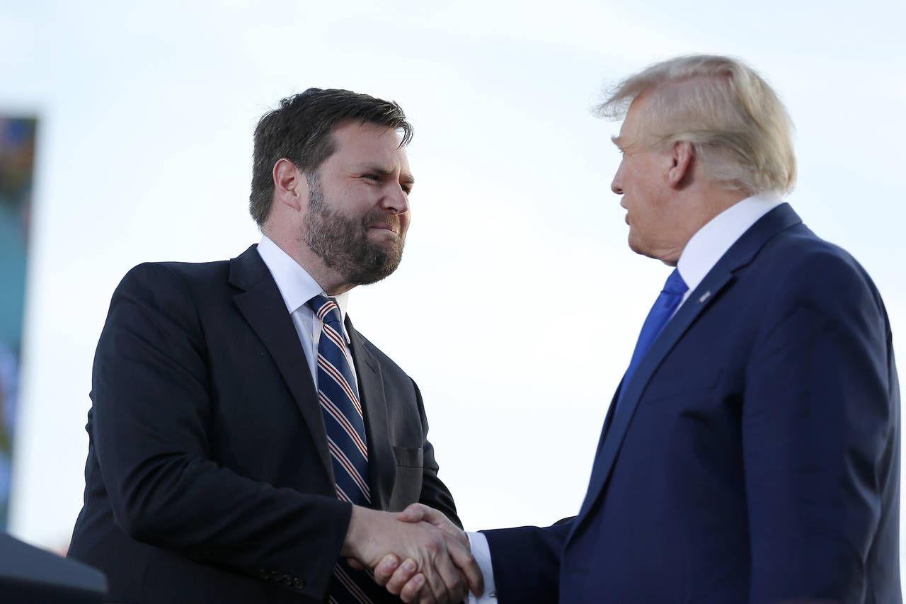 Senate candidate JD Vance, left, greets former President Donald Trump at a rally at the Delaware Co...