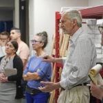 
              People look on during a tour of Utah County's elections equipment and review processes for administering secure elections Tuesday, April 19, 2022, in Provo, Utah. In Utah and other Republican-led states, unsubstantiated election fraud claims have upended support for vote by-mail, a practice that not long ago was overwhelmingly popular among Republicans. (AP Photo/Rick Bowmer)
            