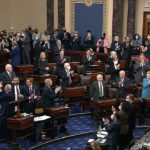
              In this image from video from Senate Television, Democrats stand and applaud after the Senate confirmed Ketanji Brown Jackson to the Supreme Court at the U.S. Capitol, Thursday, April 7, 2022, in Washington. (Senate Television via AP)
            