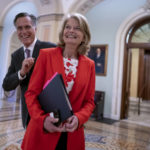 
              Republican Senators Lisa Murkowski of Alaska, and Mitt Romney of Utah, left, who say they will vote to confirm Judge Ketanji Brown Jackson's historic nomination to the Supreme Court, smile as they greet each other outside the chamber, at the Capitol in Washington, Tuesday, April 5, 2022. Murkowski and Romney join Sen. Susan Collins, R-Maine, who is also bucking the GOP leadership in giving President Joe Biden's nominee a new burst of bipartisan support to become the first Black woman on the high court. (AP Photo/J. Scott Applewhite)
            