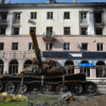 
              A destroyed tank and a damaged apartment building from heavy fighting are seen in an area controlled by Russian-backed separatist forces in Mariupol, Ukraine, Tuesday, April 26, 2022. (AP Photo/Alexei Alexandrov)
            
