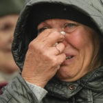 
              A woman cries as she waits in a line after fleeing the war from neighbouring Ukraine at the border crossing in Medyka, southeastern Poland, Tuesday, April 5, 2022. Ukraine’s president plans to address the U.N.’s most powerful body after even more grisly evidence emerged of civilian massacres in areas that Russian forces recently left. (AP Photo/Sergei Grits)
            