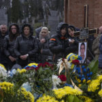 
              Family and friends attend the funeral of 37-year-old sergeant Kostiv Andrew, who was killed in action, at the Lychakiv cemetery, in Lviv, western Ukraine, Tuesday, April 5, 2022. (AP Photo/Nariman El-Mofty)
            