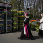 
              Hans van den Hende, bishop of Rotterdam, blesses a transport of flowers which will decorate Saint Peter's square for Easter celebrations in Vatican City, at the world-renowned Dutch flower garden Keukenhof, in Lisse, Netherlands, Tuesday, April 12, 2022. (AP Photo/Peter Dejong)
            