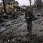 
              Konstyantyn, 70, smokes a cigarette amid destroyed Russian tanks in Bucha, in the outskirts of Kyiv, Ukraine, Sunday, April 3, 2022. (AP Photo/Rodrigo Abd)
            