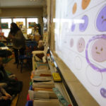 
              FILE - Second-grade teacher Melissa Shugg teaches a lesson at Paw Paw Elementary School about thoughts, feelings and actions on Dec. 2, 2021, in Paw Paw, Michigan. Shugg is one of many teachers at the school who've been trained to teach a social-emotional curriculum created at the University of Michigan called TRAILS. Research suggests TRAILS lessons for at-risk kids can reduce depression and improve coping skills — something district officials say has been particularly important during the pandemic. (AP Photo/Martha Irvine, File)
            