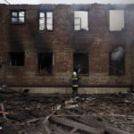 
              A firefighter works to extinguish a fire after a Russian attack destroyed the building of a Culinary School in Kharkiv, Ukraine, Tuesday, April 12, 2022. (AP Photo/Felipe Dana)
            