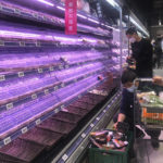 
              FILE - Customers look through empty shelves at a supermarket in Shanghai, China, on March 30, 2022. Residents of Shanghai are struggling to get meat, rice and other food supplies under anti-coronavirus controls that confine most of its 25 million people in their homes, fueling frustration as the government tries to contain a spreading outbreak. (AP Photo/Chen Si, File)
            