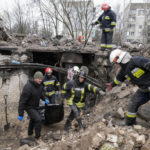 
              Emergency workers remove the body of a resident of a multi-storey building destroyed in a Russian air raid at the beginning of the Russia-Ukraine war in Borodyanka, close to Kyiv, Ukraine, Saturday, April 9, 2022.  (AP Photo/Efrem Lukatsky)
            