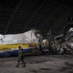 
              A Ukrainian serviceman walks past the Antonov An-225 aircraft destroyed during fighting between Russian and Ukrainian forces, at the Antonov airport in Hostomel, outskirts of Kyiv, Ukraine, Monday, April 4, 2022. (AP Photo/Felipe Dana)
            