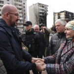 
              In this image provided by the European Council, European Council President Charles Michel, left, speaks with a woman as he is given a tour of the region of Borodyanka, Ukraine, Wednesday, April 20, 2022. (Dario Pignatelli/European Council via AP)
            