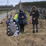 
              Natalya Verbova, 49, and her son Roman Verbovyi, 23, attend the funeral of her husband Andriy Verbovyi, 55, who was killed by Russian soldiers while serving in Bucha territorial defense, in the outskirts of Kyiv, Ukraine, Wednesday , April 13, 2022. (AP Photo/Rodrigo Abd)
            