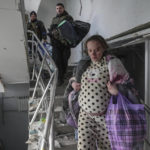 
              FILE - Mariana Vishegirskaya, an injured pregnant woman walks downstairs in a maternity hospital damaged by shelling in Mariupol, Ukraine, Wednesday, March 9, 2022. An Associated Press team of journalists was in Mariupol the day of the airstrike and raced to the scene. Their images prompted a massive Russian misinformation campaign that continues to this day. (AP Photo/Evgeniy Maloletka, File)
            