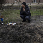 
              Tanya Nedashkivs'ka, 57, mourns the death of her husband on the site where he was buried, in Bucha, on the outskirts of Kyiv, Ukraine, Monday, April 4, 2022. Russia is facing a fresh wave of condemnation after evidence emerged of what appeared to be deliberate killings of civilians in Ukraine. (AP Photo/Rodrigo Abd)
            